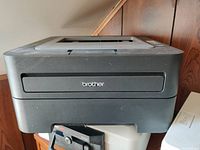 Brother laser printer front view showing brand name and tray