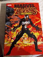 Front cover of Marvel Zombies The Covers hardcover comic book showing Venom in zombie form with a fiery background