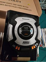 Panasonic Shockwave Discman black and silver portable CD player with orange buttons and anti-skip feature label.