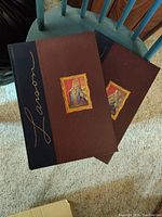 View of two hardcover books with black and brown covers showing front cover design with framed illustrations and Gary Larson's signature