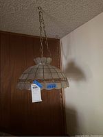 Photo of one of the matching hanging lamps with dome-shaped stained glass style shade and chain for hanging