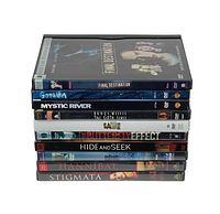 Stack of 10 DVD cases showing spines with movie titles Final Destination, Gothika, Mystic River, The Sixth Sense, Saw II, The Butterfly Effect, Hide and Seek, Hannibal, Stigmata