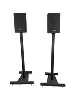 Full front view of both Cambridge Soundworks speakers mounted on black metal stands, showing rectangular speakers with cloth grills and stands with stable bases.