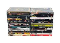 Photo of stacked DVD cases with visible titles including The Mummy, Matrix Reloaded, The Recruit, Star Wars: The Phantom Menace, Fight Club, Bad Boys II, and others.