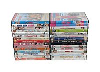 Photo showing all 30 DVDs stacked in two columns, revealing the spines of movies included in the lot.