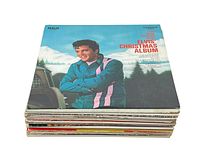 Stack of assorted LP records with Elvis Christmas Album on top