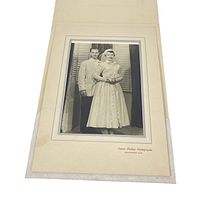Full front view of the mounted black and white wedding portrait showing bride and groom in 1940s attire.