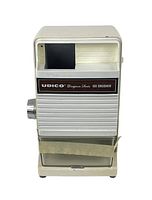 Front view of vintage Udico electric ice crusher showing brand label, metal ice collection bin, and overall condition.