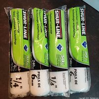Photo shows 4 Shur-Line paint rollers in original packaging. Packaging highlights 240mm width and 1/4 inch nap. White roller covers appear new and unused.