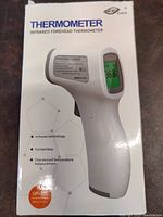 Box of the thermometer showing product name, infrared technology, contactless, one second measurement, model GP-300 logo.