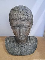 Front view of the Greek bust showing detailed facial features and armor