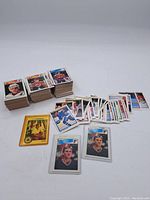 Wide photo showing stacks of hockey cards laid out, including separated group with Eric Lindros and Brett Hull cards in front.