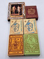 Four vintage playing card decks displayed together showing box designs