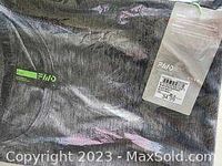Close-up of a sealed men's plush tank top in dark gray fabric with FWD logo and tag showing size X-Large.