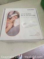 Photo of box packaging showing the anti aging pillow product image and title.