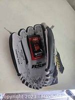 White and black Rawlings youth baseball glove showing the brand mark and model RSG.