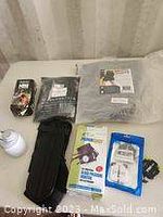Lot laid out showing all items including Sawyer Mini Water Filtration box, cooling gel pack, knee brace, and other wellness accessories