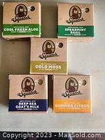 Five bars of Dr. Squatch mens soap with visible labels including Cool Fresh Aloe, Spearmint Basil, Gold Moss, Deep Sea Bars Mix, and Summer Citrus, stacked and arranged for display.