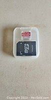 Photo of the micro SD card inside clear plastic case showing the card's label and capacity of 1024GB.