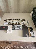 Full overview of the lot showing watch bands spread out and repair kit in black case on table