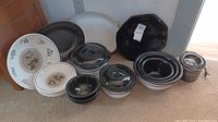 Wide shot of all items in the set showing Himark platters, black hexagon plates, black and white bowls, and crockpot.