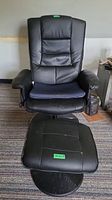 Front view of black vegan leather swivel chair and matching ottoman, showing wear and tear on seat and armrests.