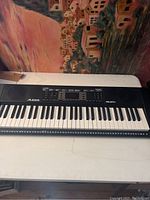 Full view of Alesis Melody 61 electronic keyboard showing the entire keyboard, keys, control panel, and branding.