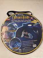 Front packaging of deluxe Dream Tents bed tent showing product features and images of the tent in use.