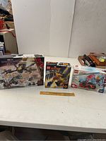 Three LEGO Marvel boxed sets including Spider-Man No Way Home drone duel, Wolverine mech, and Spider-Man vehicle.