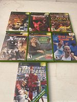 Lot of 8 Xbox games arranged in two rows showing front covers with titles and publisher logos.