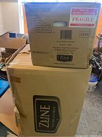 Two original packed boxes labeled ZLine Kitchen and Bath containing kitchen exhaust components.