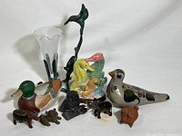 Full assortment of animal figurines and metal hummingbird vase on display