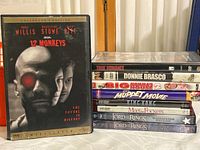 Photo showing front cover of 12 Monkeys Collector's Edition DVD and stacked spines of other DVD cases including True Romance, Donnie Brasco, Big Momma's House 2, The Muppet Movie, King Kong HD DVD, Meet the Fockers HD DVD, and two Lord of the Rings DVDs.