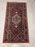 Full view of the small rectangular area rug showing overall pattern and color scheme