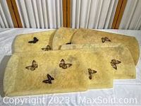 Set of six butterfly design fiberglass TV trays stacked together.