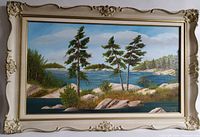 Front view of the oil painting in original frame showing landscape of Parry Sound shore with pine trees, rocks, water and sky.