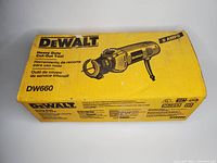 Closed original DeWalt box for model DW660 5 amp heavy duty cut-out tool with yellow branding and black product image.
