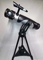 Side view of EduScience telescope mounted on black tripod stand