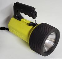 Full side view of yellow King Pelican Lite underwater flashlight with black handle and large lens housing
