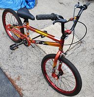 Front and side view of the BMX bike showing frame, tires, handlebars, and seat.