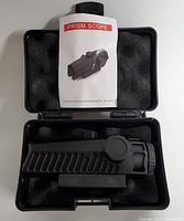 Prism scope in protective foam case with instruction manual.