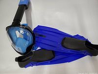 Full face snorkel mask with integrated snorkel attached and pair of blue Shoreline fins by Akona.