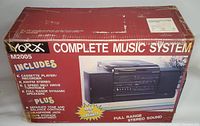 Original Yorx M2005 system box showing product information and features including cassette player/recorder, AM/FM stereo, 2-speed belt drive turntable, and full range dynamic speakers.