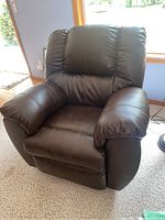 Front left angle shot showing padded arms, cushioned seat and back