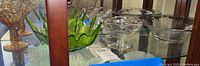 Green glass bowl, amber footed candy dish, clear glass serving bowls and candy dishes.