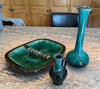 Three Blue Mountain Pottery pieces together on stone countertop showing ashtray, vase, and sauce jar.