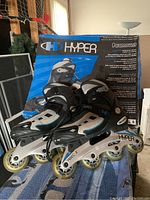 Pair of Hyper Paramount inline rollerblades next to original box showing size 6 and product branding