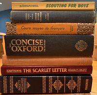 Books stacked showing spine titles and condition