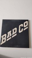 Front cover of Bad Company vinyl record sleeve with bold white lettering against black background
