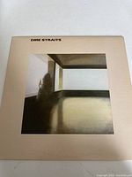 Front cover of Dire Straits vinyl album showing artistic room and figure image